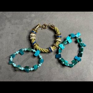 Costume jewelry bracelets one set blue paired with a gold bracelet with charms